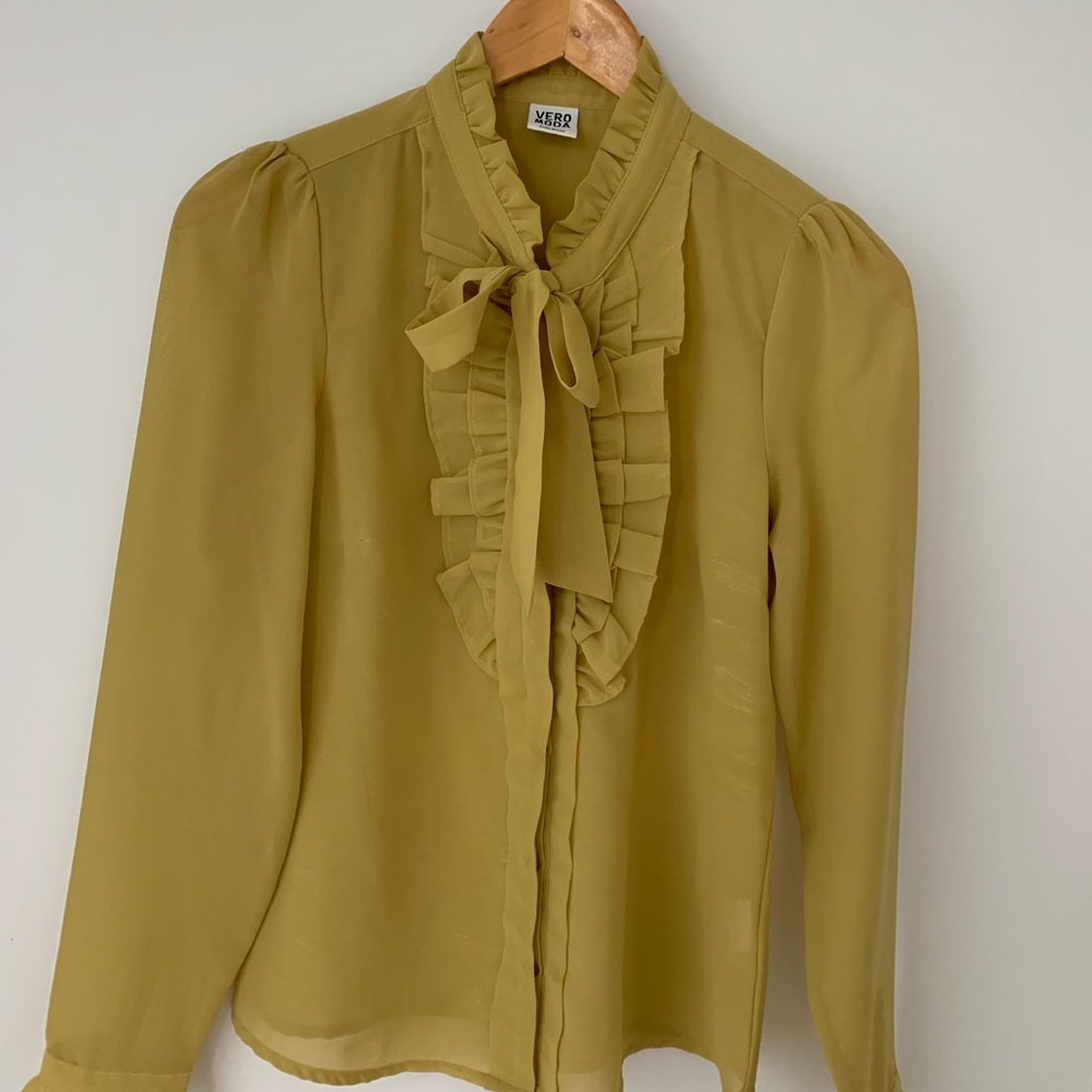 Ruffle detail; tie neck top